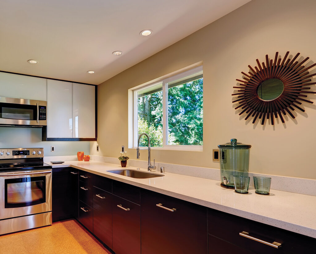 Modern kitchen with white countertops and brown new cabinets.
