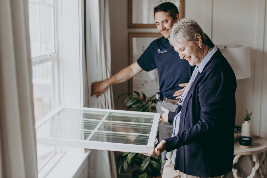 HomeRite worker and customer looking over window replacement